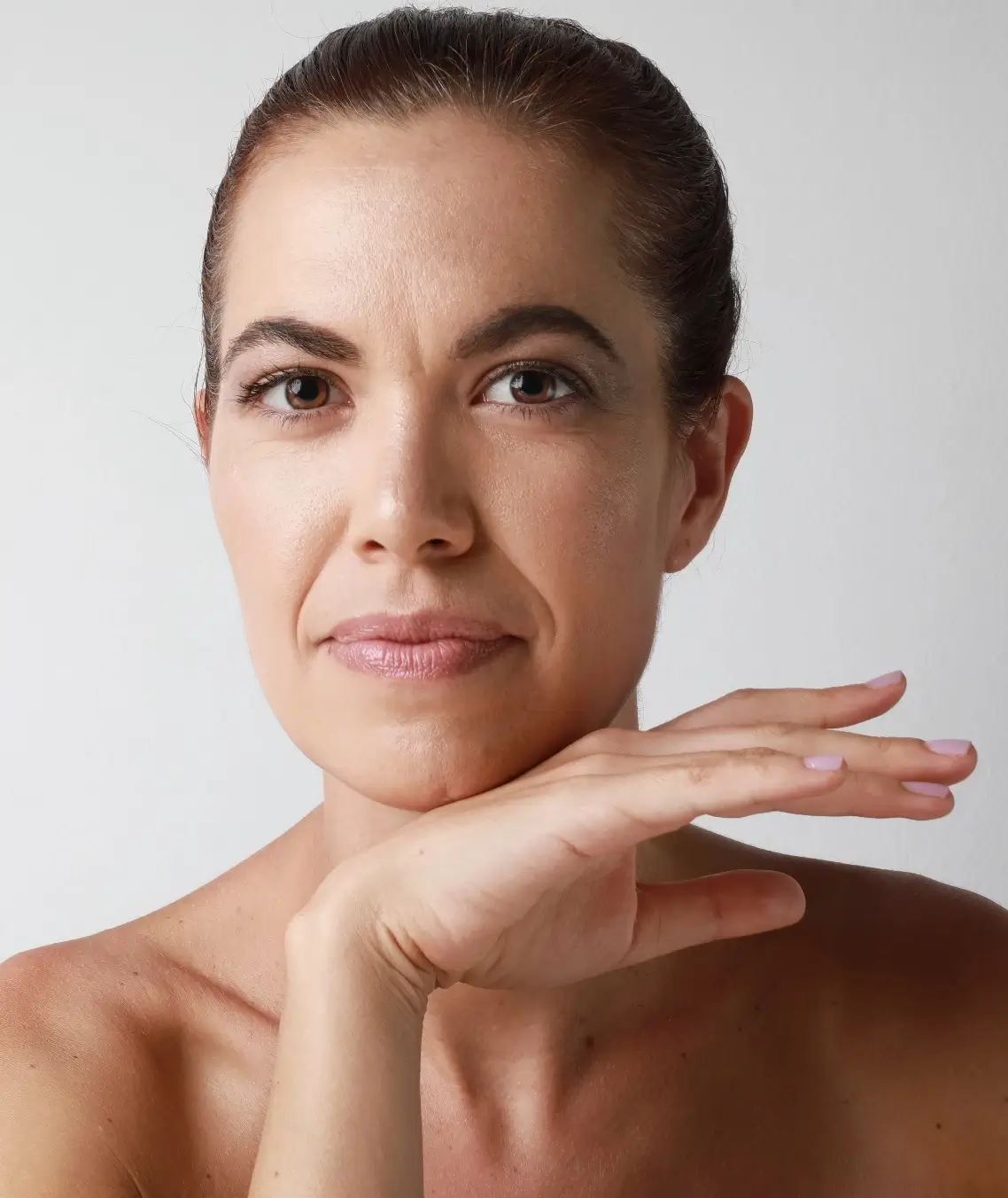 older woman posing with her hand | Ingram Cosmetic Surgery Nashville