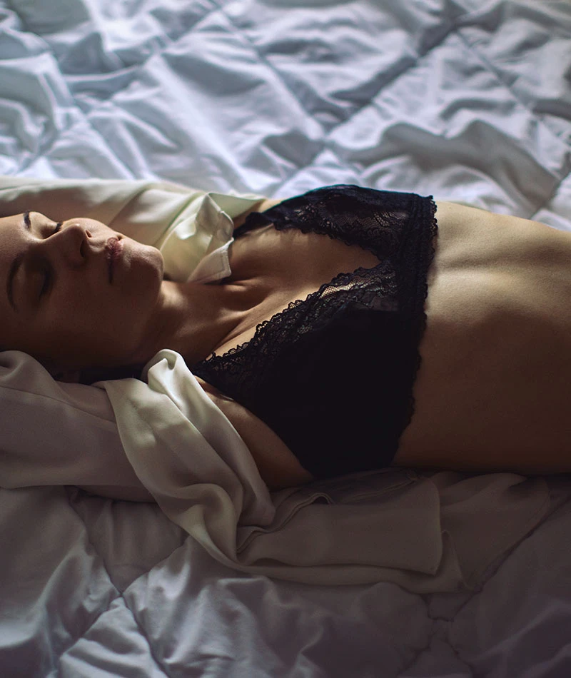 Woman laying in bed with bra bralette | Ingram Cosmetic Surgery